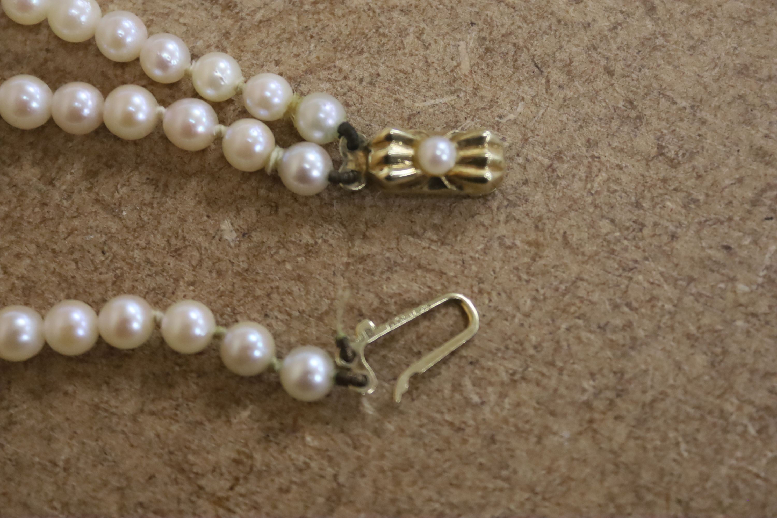 A double strand graduated cultured pearl necklace, with 9ct gold and cultured pearl set clasp, approx. 40cm.